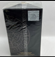 Black decorative item with intricate patterns on a white background