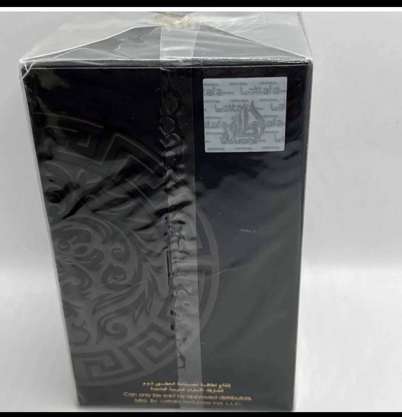Black decorative item with intricate patterns on a white background